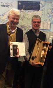 Speyside Distillery CEO John Harvey McDonough (left) presents successful bidder James Robertson with bottle number one from Cask 27